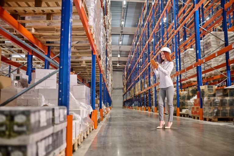 woman-working-tablet-standing-warehouse_259150-56877